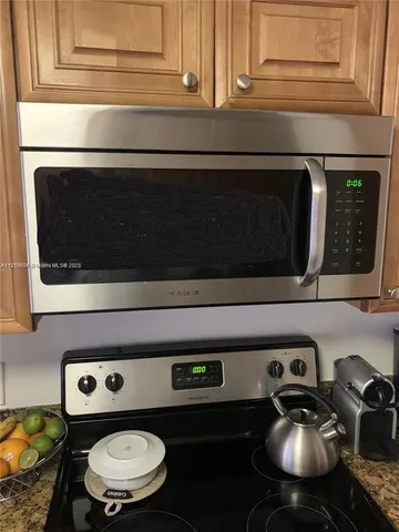 a view of a lake with couches chairs and swimming pool with a yard