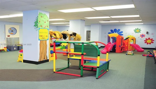 an aerial view of a swimming pool with outdoor seating