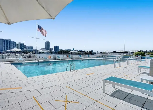 a view of a swimming pool and lounge chair
