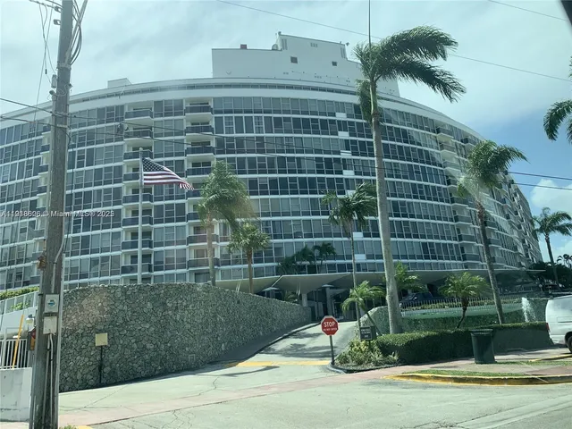 a living room with fireplace furniture and large windows