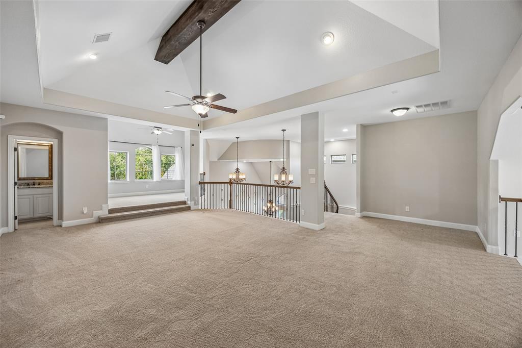 134 Santa Rosa Way Irving, TX 75062 - Photo 19 of 26 Expansive game room with vaulted ceilings, exposed beam detail, and flexible space for entertaining or everyday living.