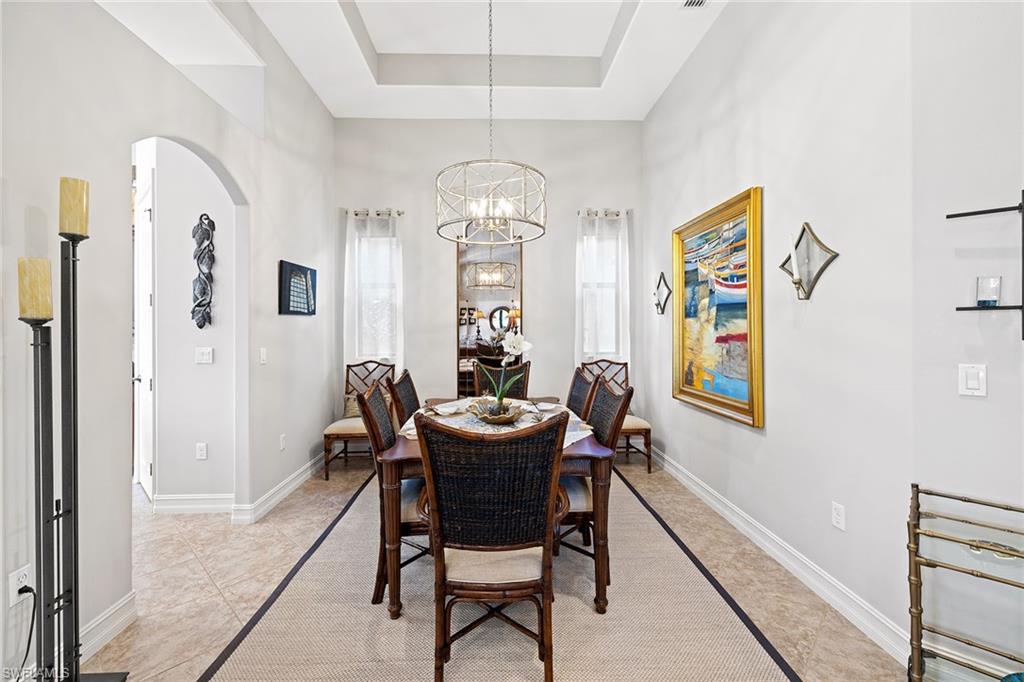 6513 Caldecott Drive Naples, FL 34113 - Photo 11 of 33 a view of a dining room with furniture window and wooden floor