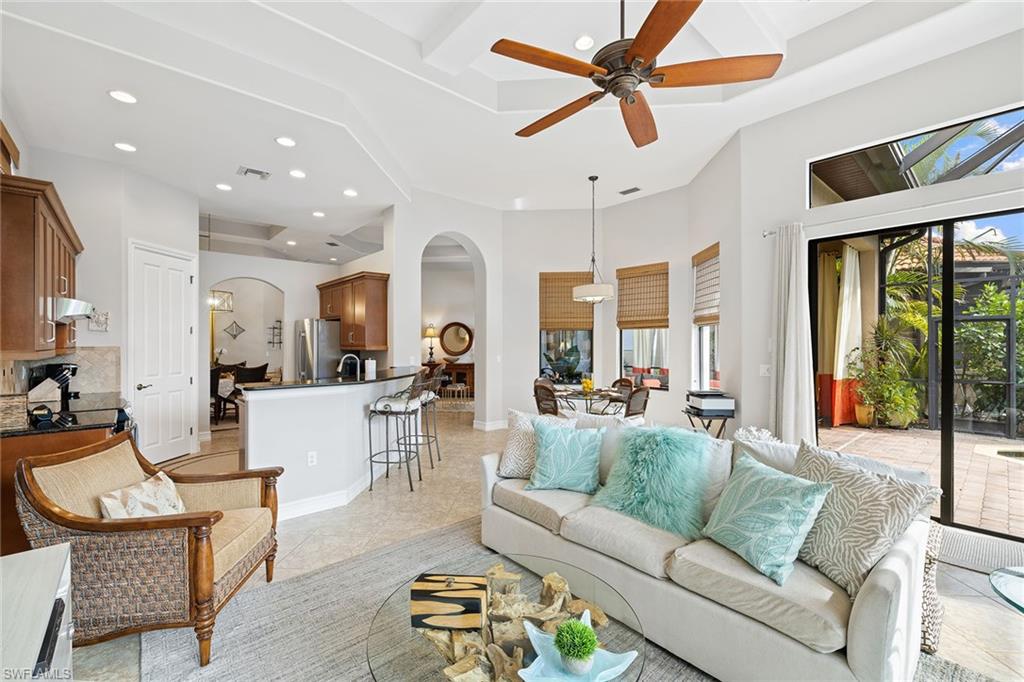 6513 Caldecott Drive Naples, FL 34113 - Photo 20 of 33 a living room with furniture and a large window