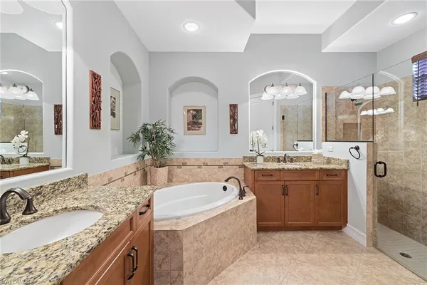 a bathroom with a granite countertop sink a large mirror and shower