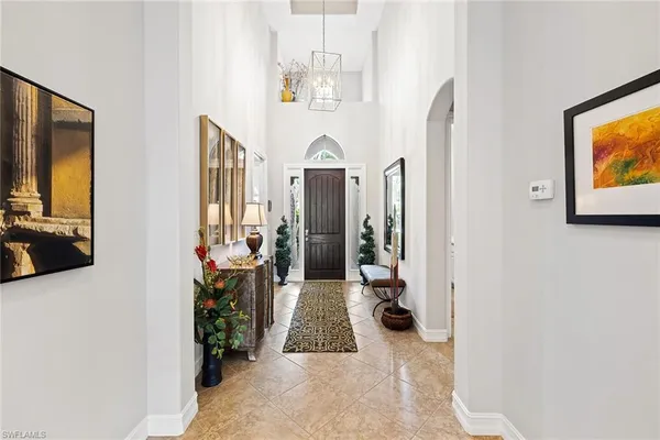 a view of hallway with furniture and a flat screen tv