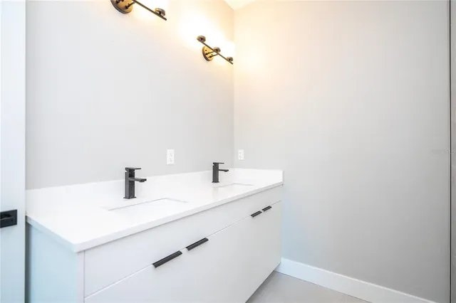 a front view of a house with a garden and yard