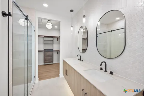 a bathroom with a tub sink and mirror