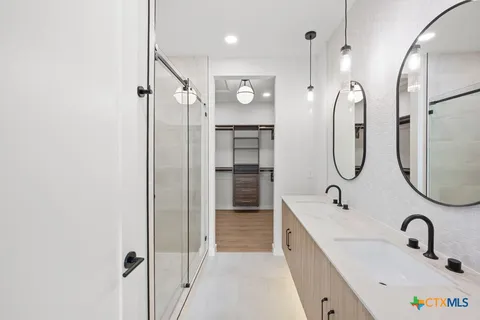 a bathroom with a tub sink and mirror