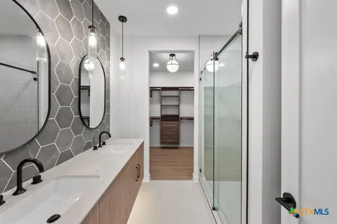 a bathroom with a sink double vanity and a mirror