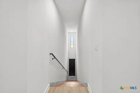 a view of a hallway with a kitchen