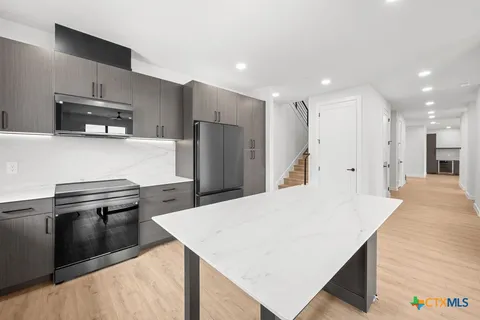 a view of livingroom with hardwood floor and hallway
