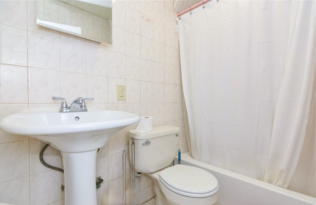 94 Summer Street Lawrence, MA 01840 - Photo 18 of 28 a bathroom with a sink toilet and shower