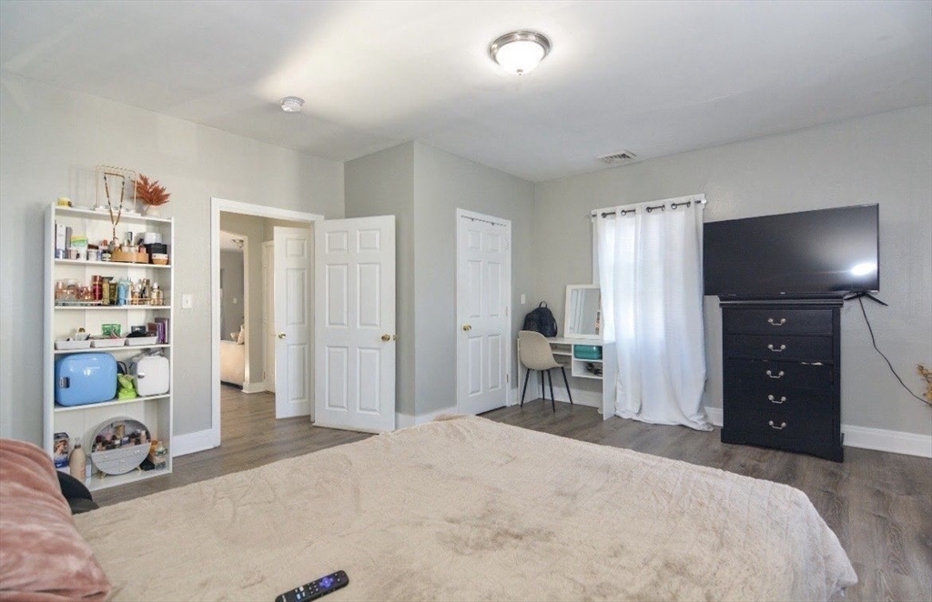 94 Summer Street Lawrence, MA 01840 - Photo 22 of 28 a bedroom with a bed and a tv
