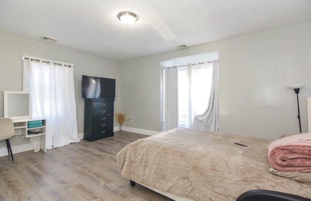 94 Summer Street Lawrence, MA 01840 - Photo 23 of 28 a bedroom with a bed and a large mirror