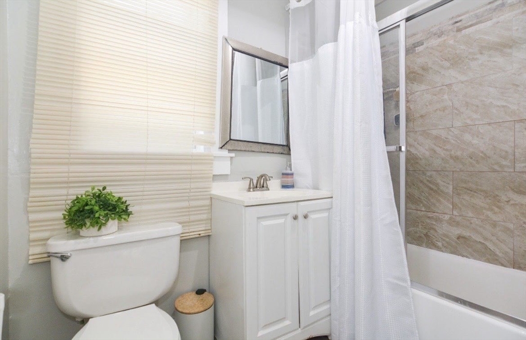 94 Summer Street Lawrence, MA 01840 - Photo 24 of 28 a bathroom with a toilet sink and shower