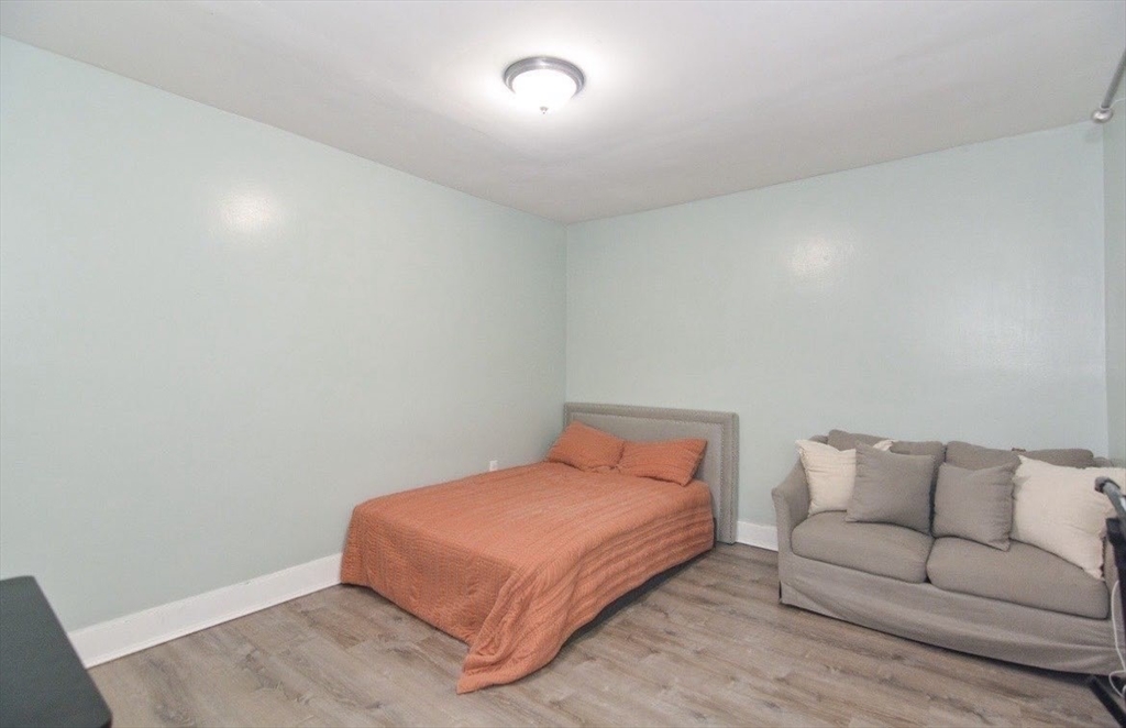 94 Summer Street Lawrence, MA 01840 - Photo 26 of 28 a bedroom with a bed and a couch