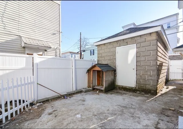 a living room with furniture and floor to ceiling window