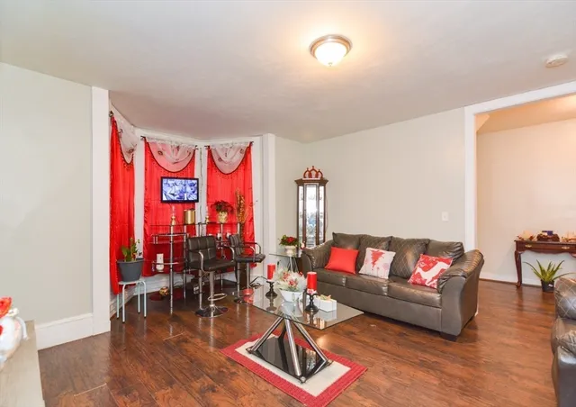 a living room with furniture and flowers