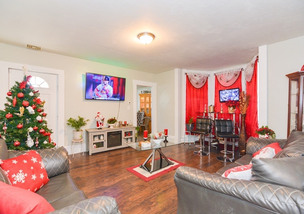 94 Summer Street Lawrence, MA 01840 - Photo 7 of 28 a living room with furniture and flowers