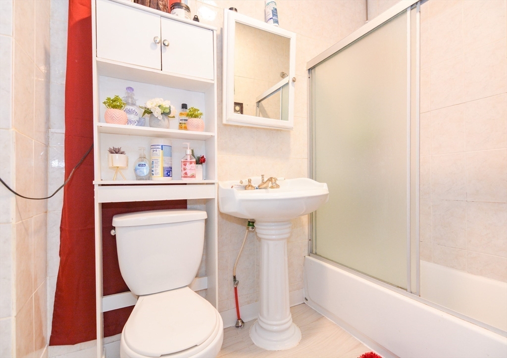 94 Summer Street Lawrence, MA 01840 - Photo 9 of 28 a bathroom with a sink a toilet and a shower