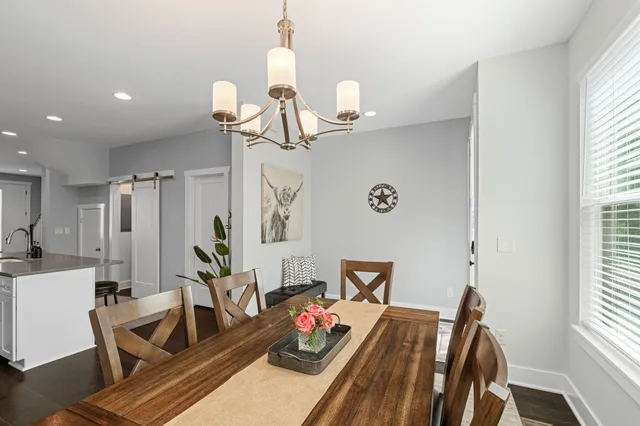 a view of a livingroom with furniture wooden floor and a chandelier