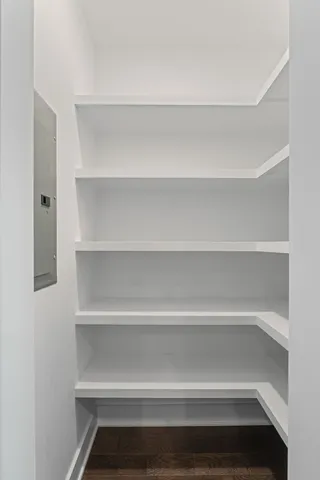 a view of walk in closet with empty racks