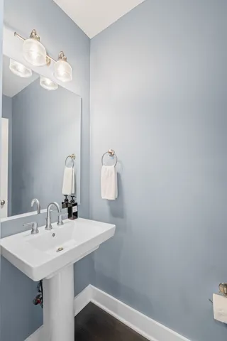 a bathroom with a sink a mirror and vanity