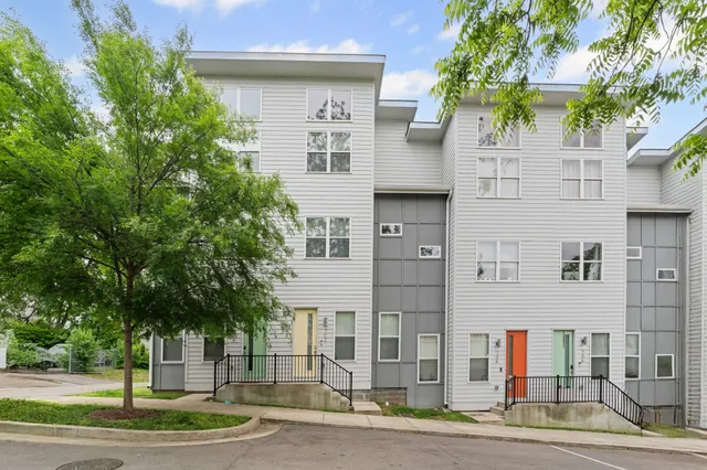 a front view of a building with tree s