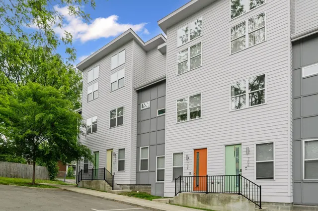 a view of a white building among the street