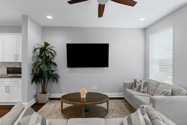 a living room with furniture and a flat screen tv