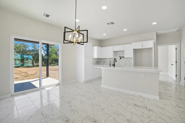 a view of kitchen with stainless steel appliances refrigerator oven and cabinets