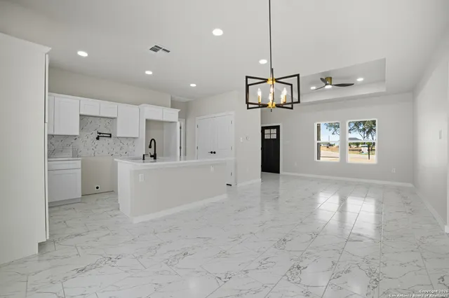 a view of a kitchen with center island and stainless steel appliances