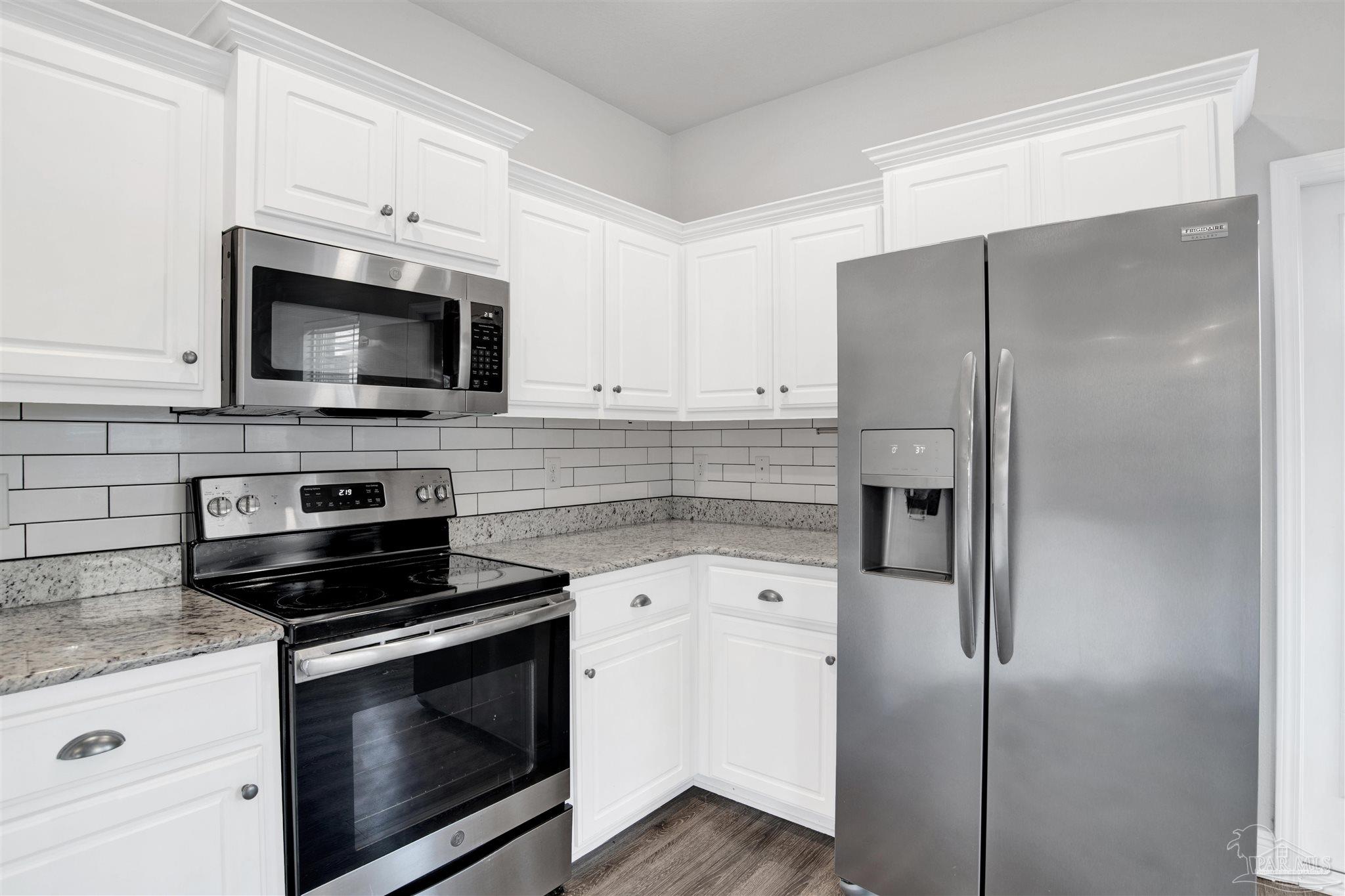 12295 Pinfish Road Pensacola, FL 32506 - Photo 14 of 34 a kitchen with cabinets stainless steel appliances and a counter space