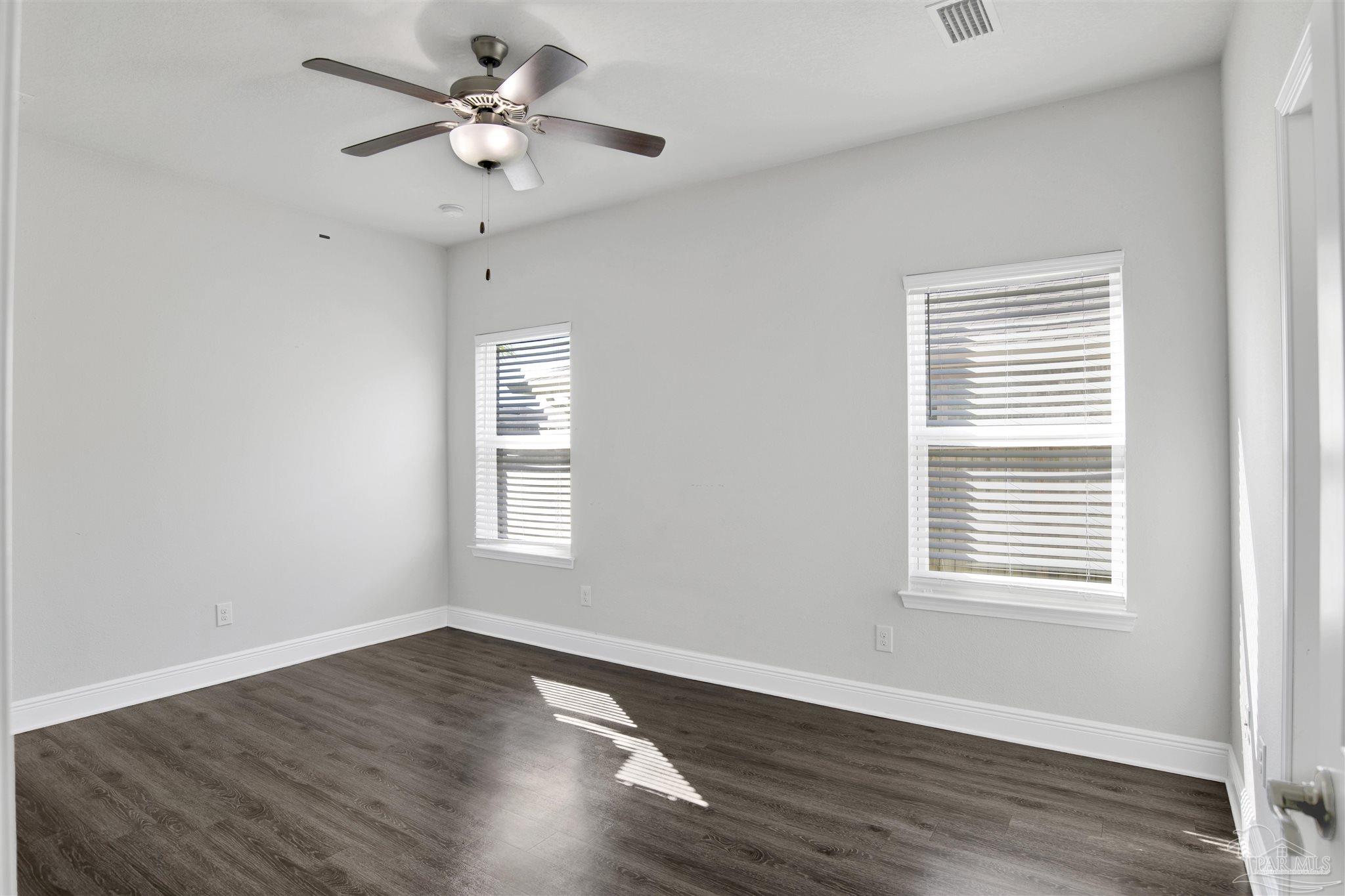 12295 Pinfish Road Pensacola, FL 32506 - Photo 17 of 34 a view of an empty room with wooden floor and a window