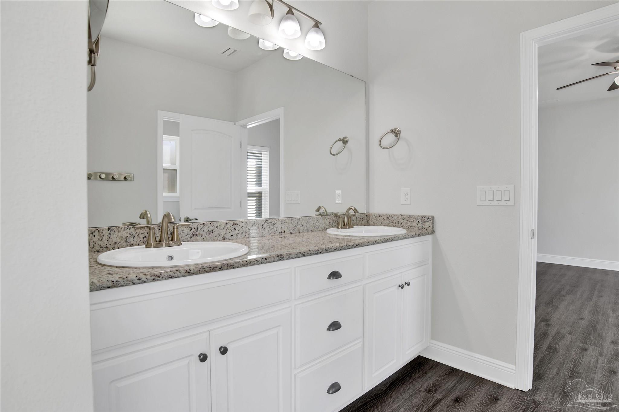 12295 Pinfish Road Pensacola, FL 32506 - Photo 19 of 34 a bathroom with a granite countertop double vanity sink and mirror