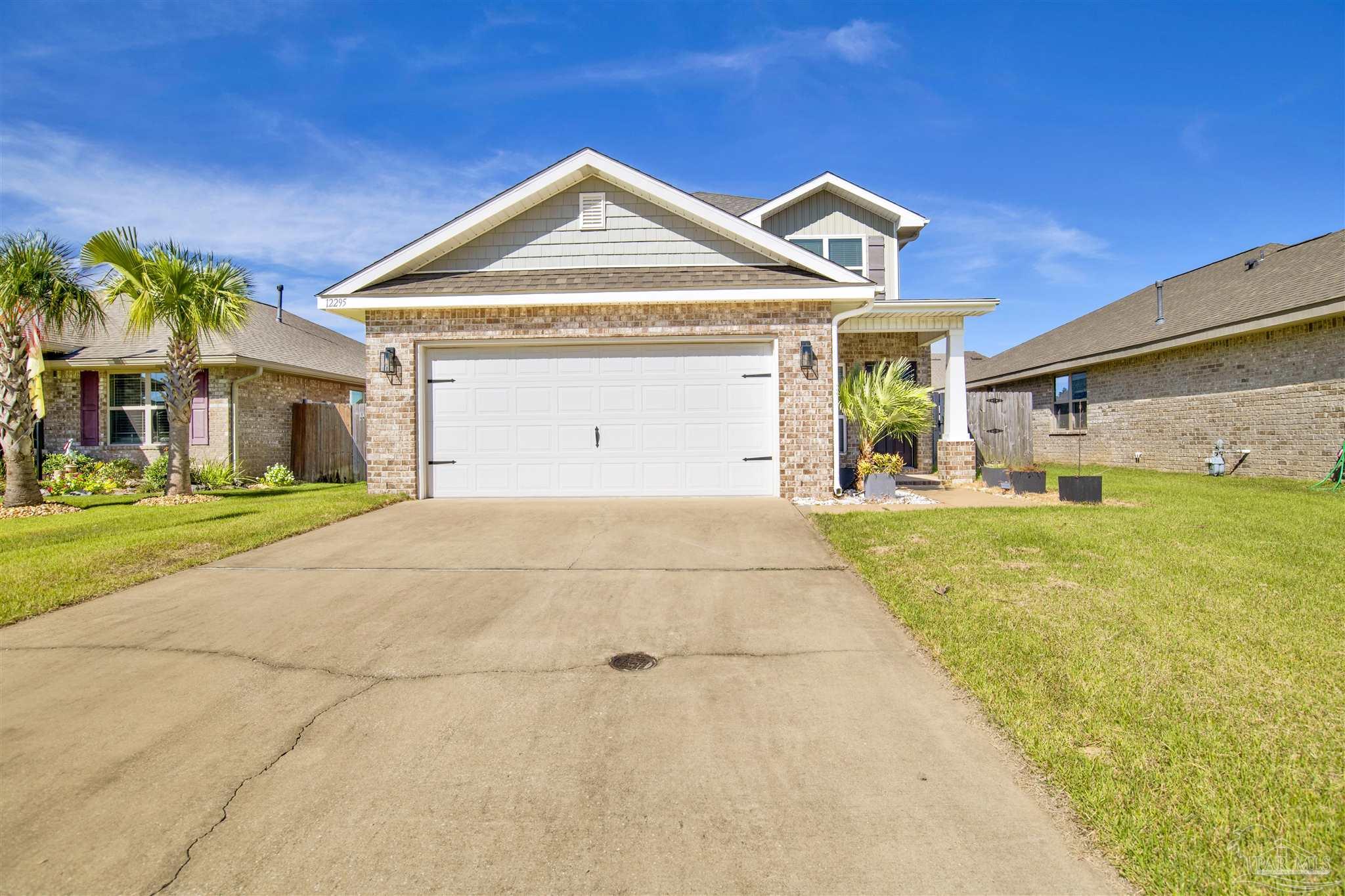 12295 Pinfish Road Pensacola, FL 32506 - Photo 2 of 34 a front view of a house with garden