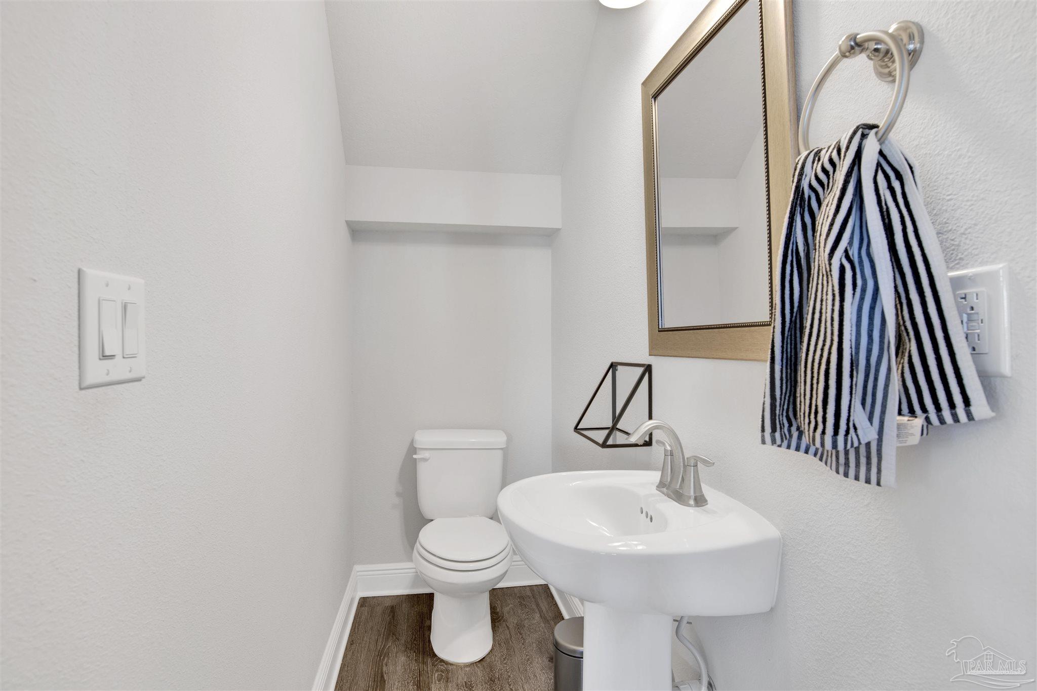 12295 Pinfish Road Pensacola, FL 32506 - Photo 21 of 34 a bathroom with a sink a toilet and mirror