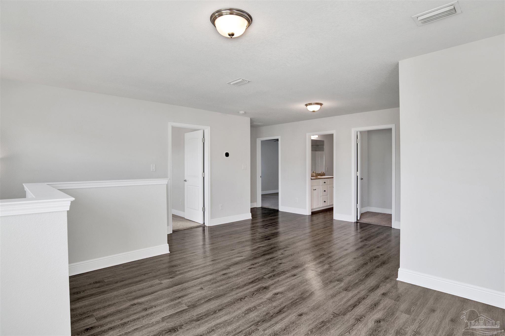 12295 Pinfish Road Pensacola, FL 32506 - Photo 26 of 34 a view of an empty room with wooden floor and a window