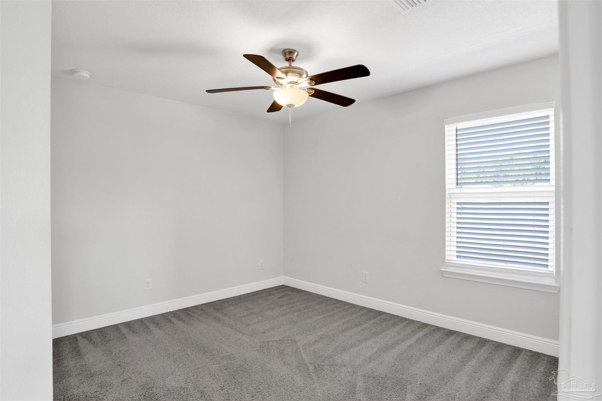 12295 Pinfish Road Pensacola, FL 32506 - Photo 29 of 34 an empty room with a window and a fan