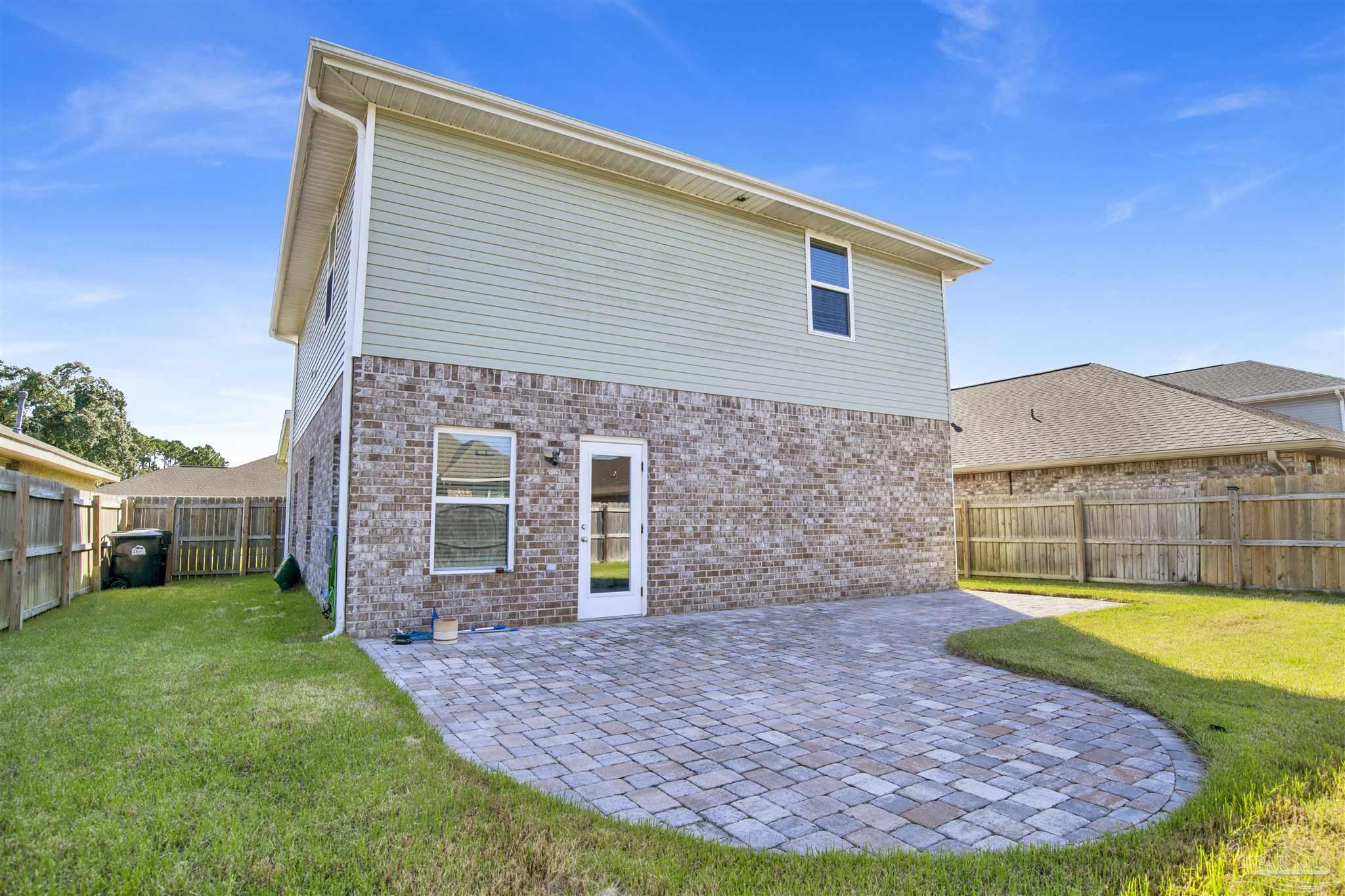 12295 Pinfish Road Pensacola, FL 32506 - Photo 32 of 34 a view of a house with a backyard and a patio