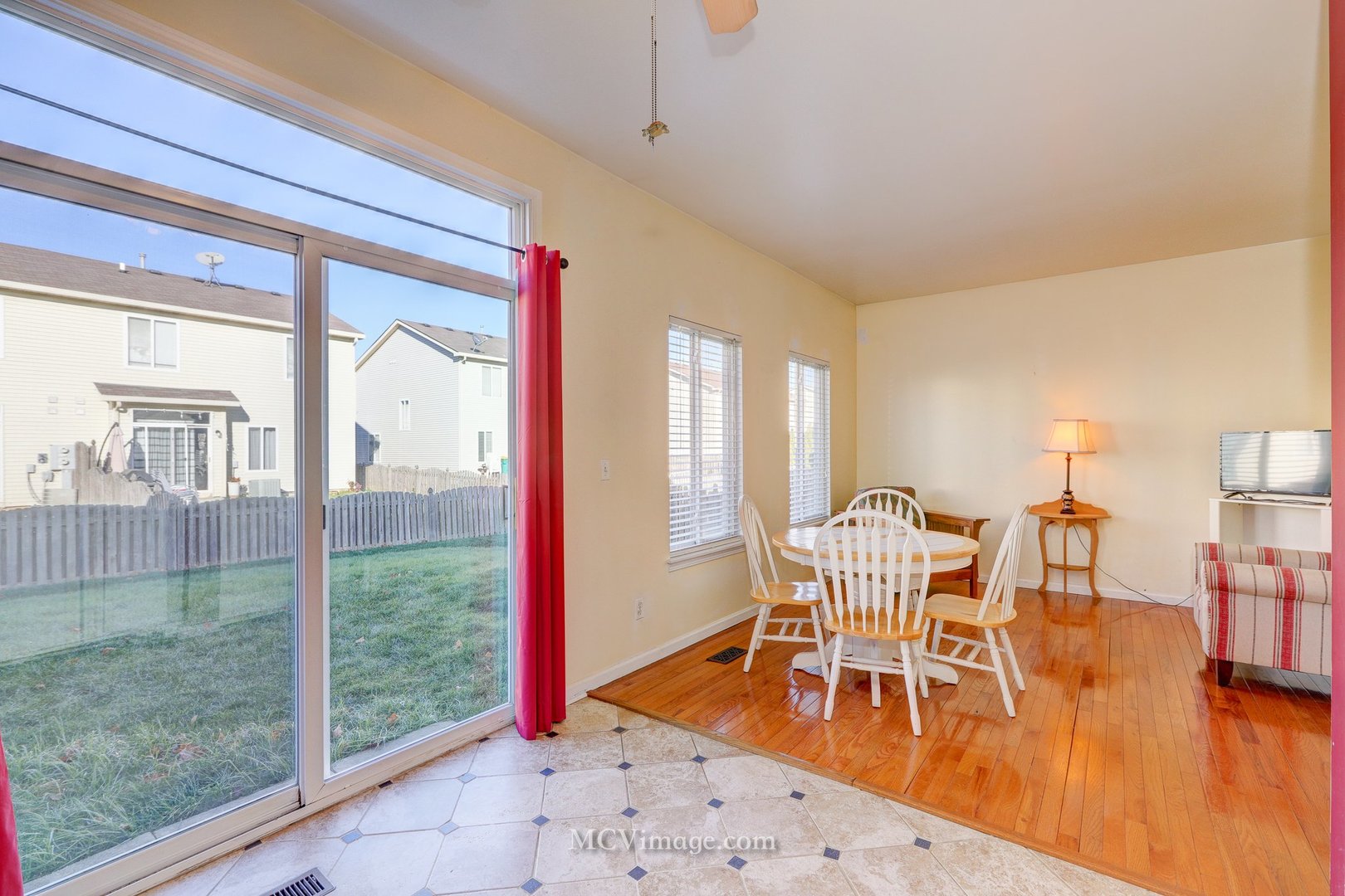 317 Reston Circle Romeoville, IL 60446 - Photo 11 of 15 a dining room with wooden floor a chandelier a glass table and chairs