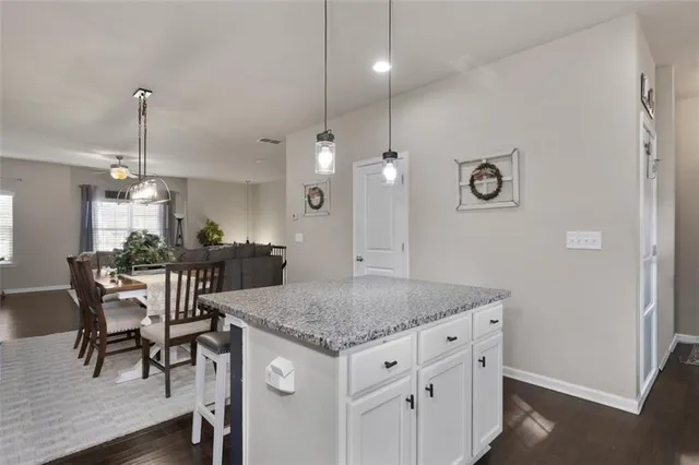 a kitchen with a table chairs and chandelier