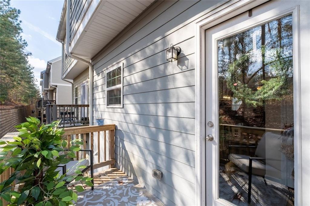 4180 Chatham Ridge Drive Buford, GA 30518 - Photo 16 of 43 a view of a house with a large window and potted plants