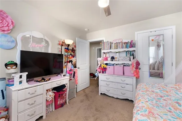 a bedroom with furniture and a flat screen tv