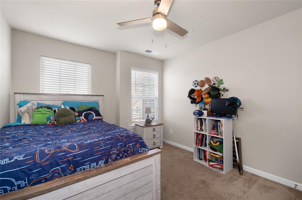 4180 Chatham Ridge Drive Buford, GA 30518 - Photo 22 of 43 a bedroom with a bed and a dresser
