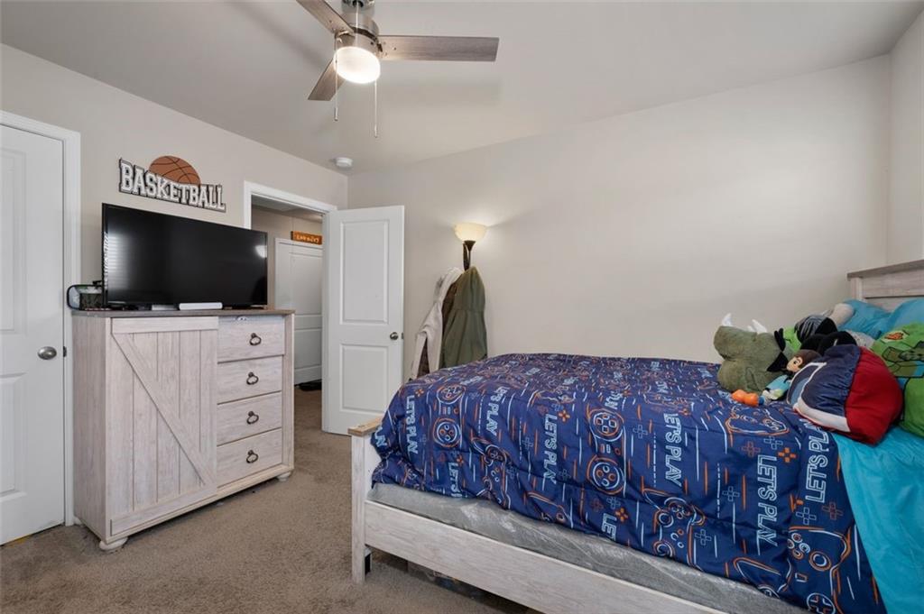 4180 Chatham Ridge Drive Buford, GA 30518 - Photo 23 of 43 a bedroom with a bed and flat screen tv