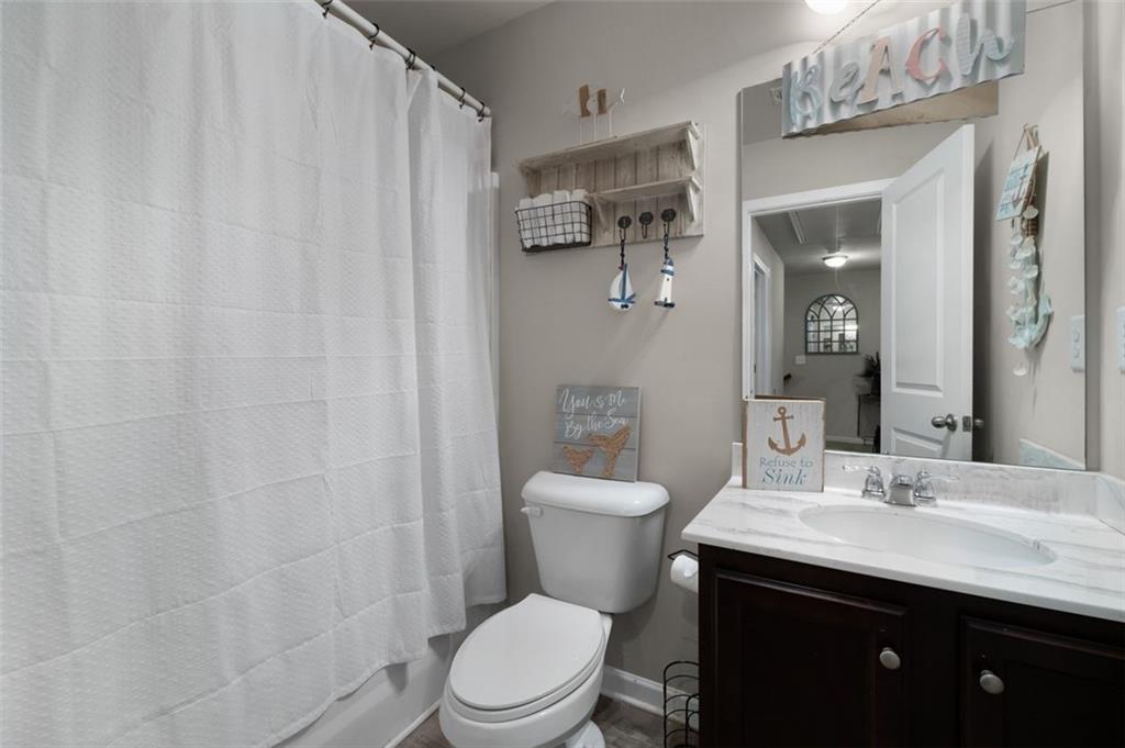4180 Chatham Ridge Drive Buford, GA 30518 - Photo 24 of 43 a bathroom with a sink a toilet and shower