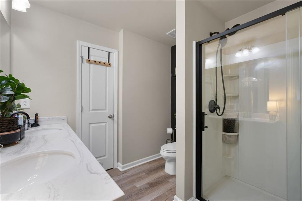 4180 Chatham Ridge Drive Buford, GA 30518 - Photo 27 of 43 a bathroom with a tub and shower