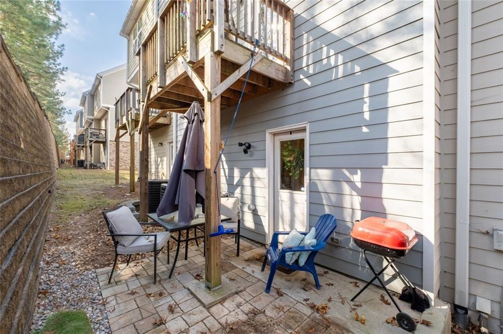 4180 Chatham Ridge Drive Buford, GA 30518 - Photo 30 of 43 a backyard of a house with barbeque oven table and chairs