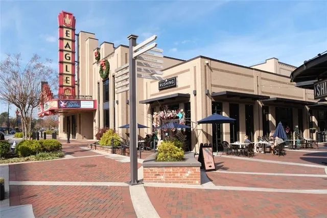 a view of swimming pool with outdoor seating and plants